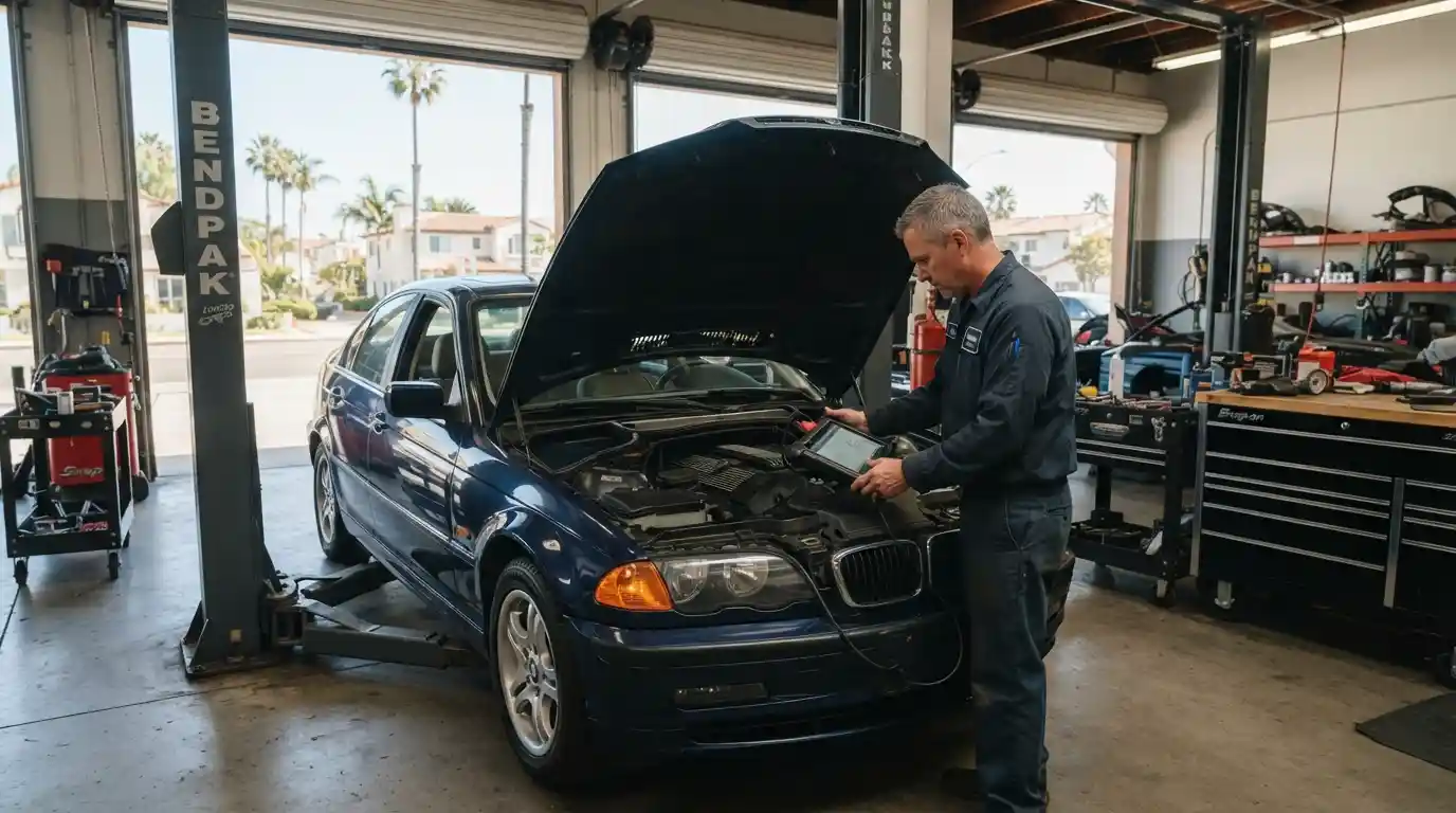 Mechanic inspecting a foreign vehicle inside a professional auto repair shop in Encinitas